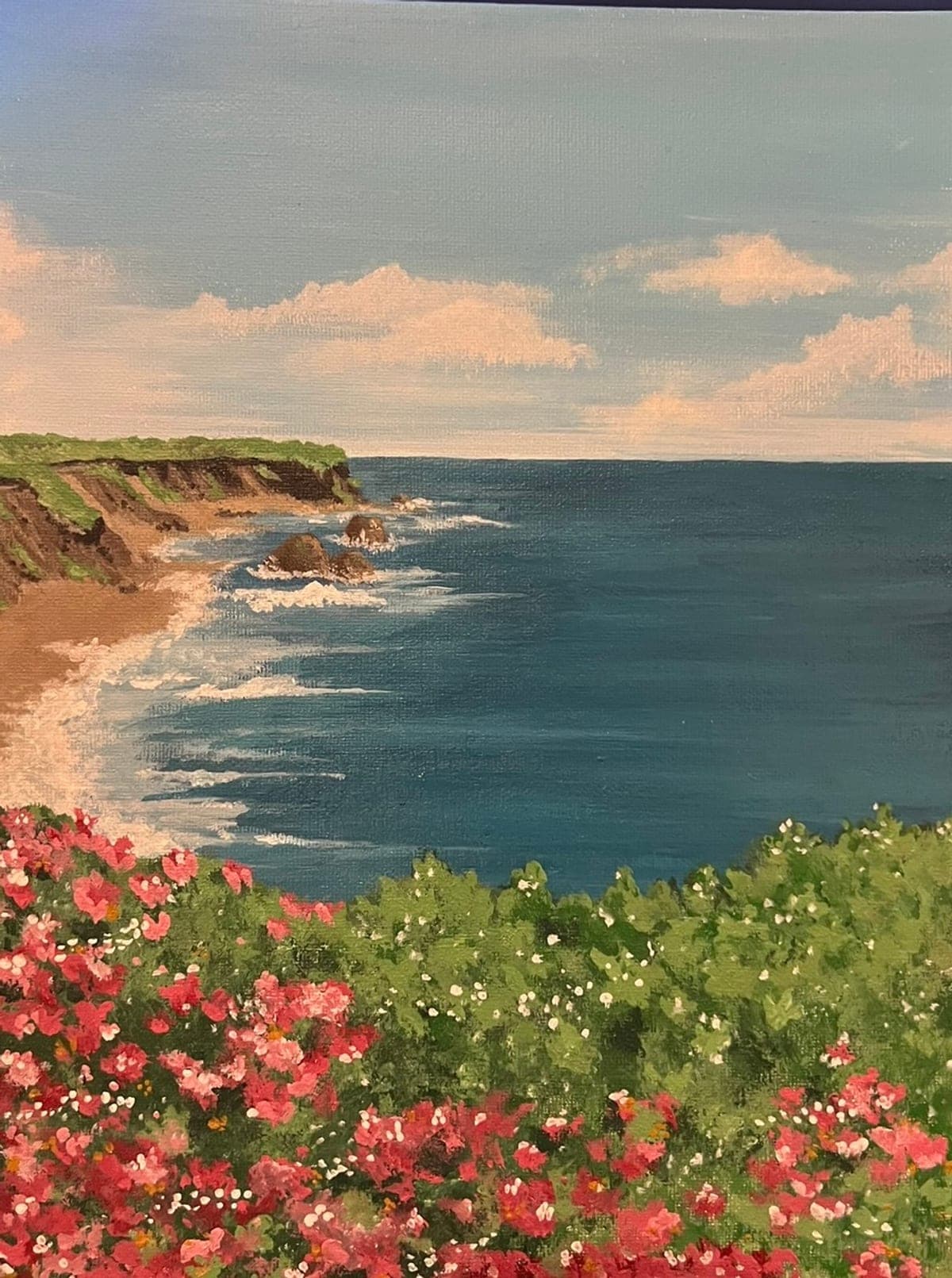 Acrylic painting of a coastline with pink wild roses